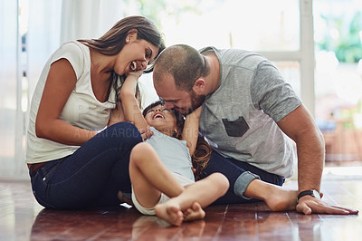 Buy stock photo Family, parents with their daughter playing and happy in living room of their home. Love or care, support and cheerful or happy people spend quality or bonding time together on floor at their house.