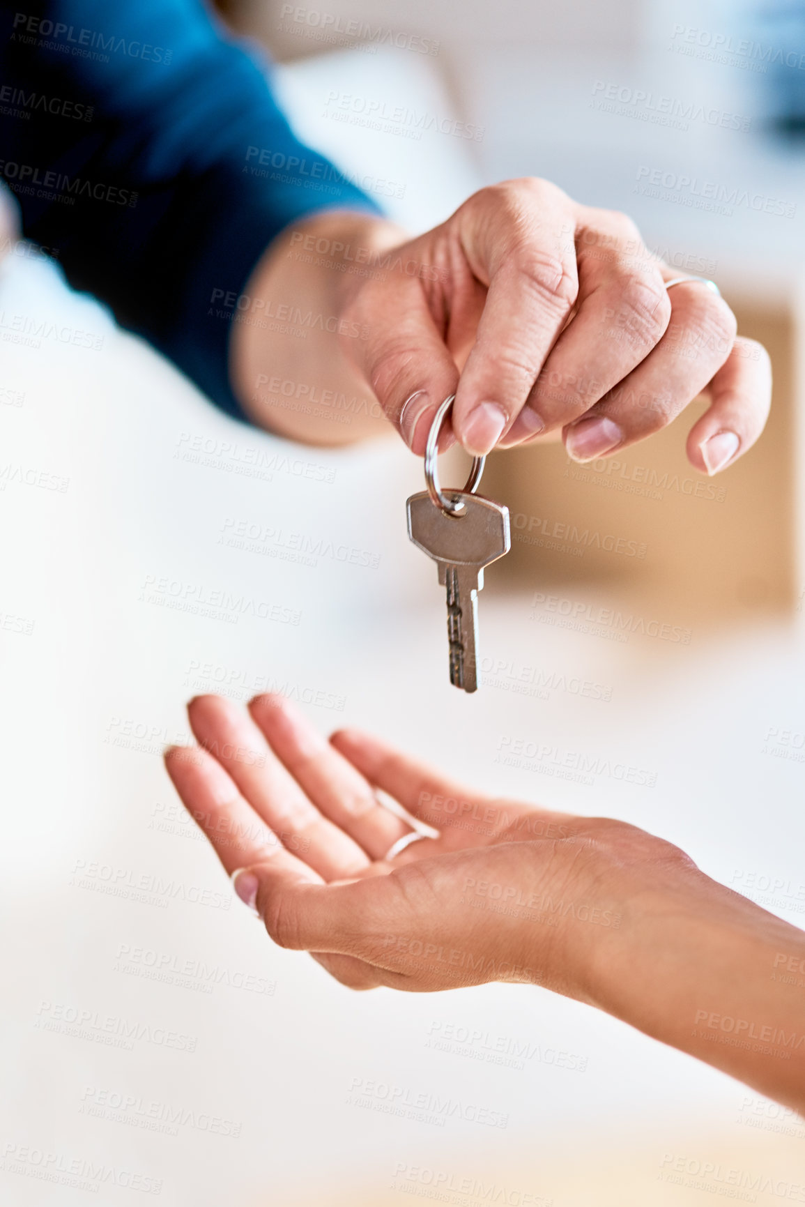 Buy stock photo Shot of a unrecognizable person receiving a key from another person inside during the day