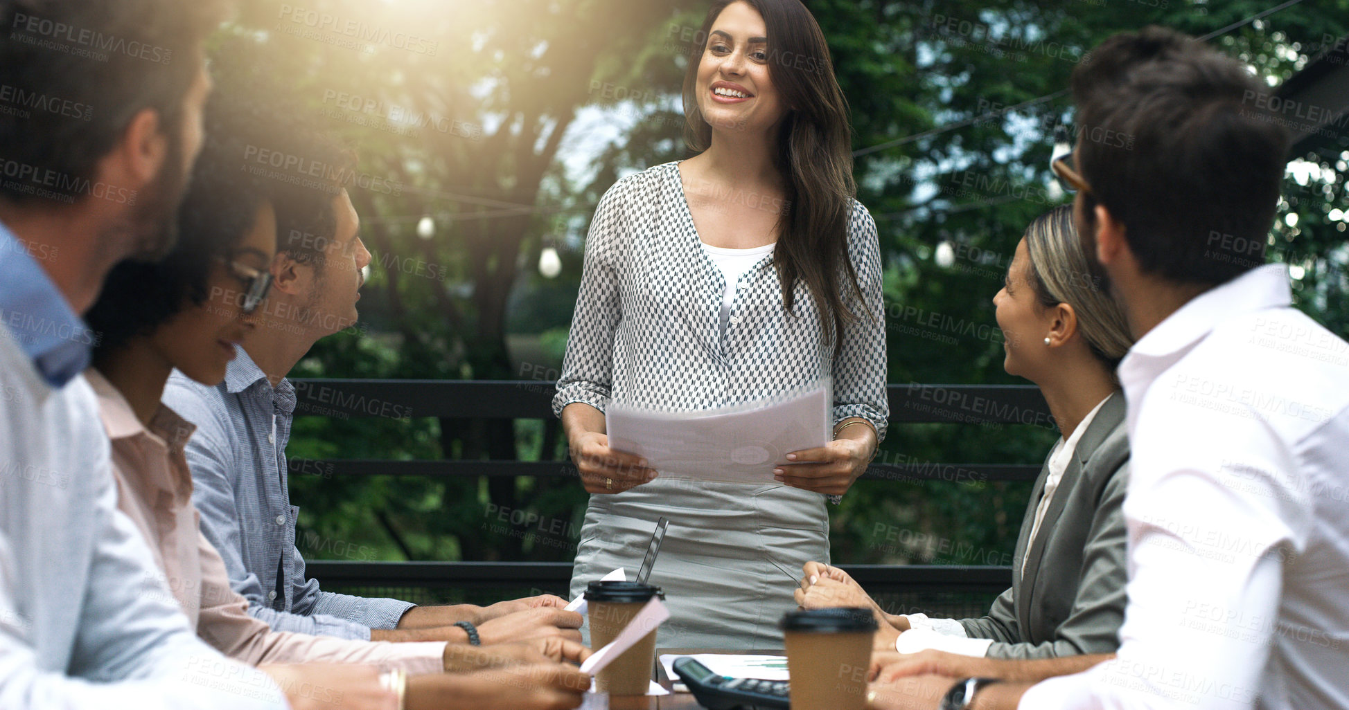 Buy stock photo Shot of a group of businesspeople having a meeting at a cafe