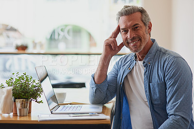 Buy stock photo Portrait of a handsome mature man using a laptop at a table in a cafe