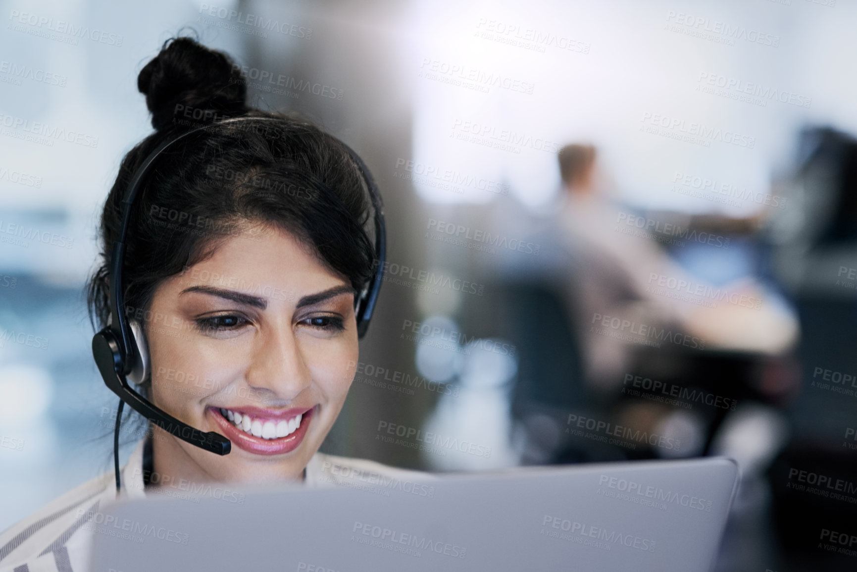 Buy stock photo Shot of a young call centre agent working in an office