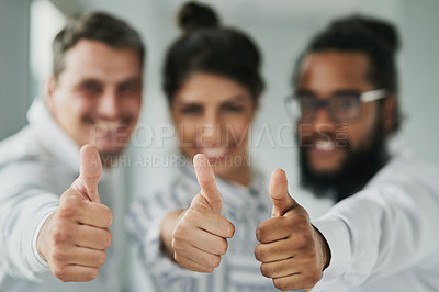 Buy stock photo Portrait of a group of businesspeople showing thumbs up in an office