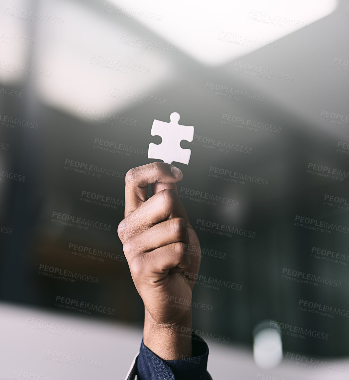Buy stock photo Closeup shot of an unrecognizable businessman holding a puzzle piece in an office