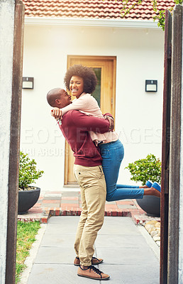 Buy stock photo Shot of a young couple celebrating the move into their new house