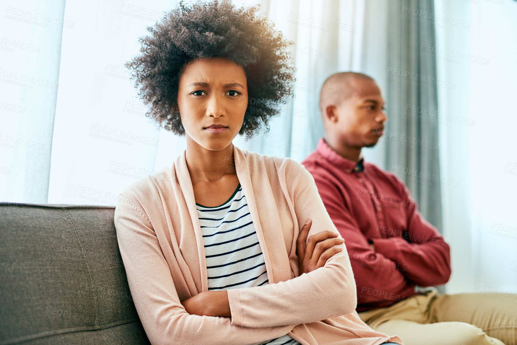 Buy stock photo Portrait of a young woman looking upset after having a fight with her partner at home