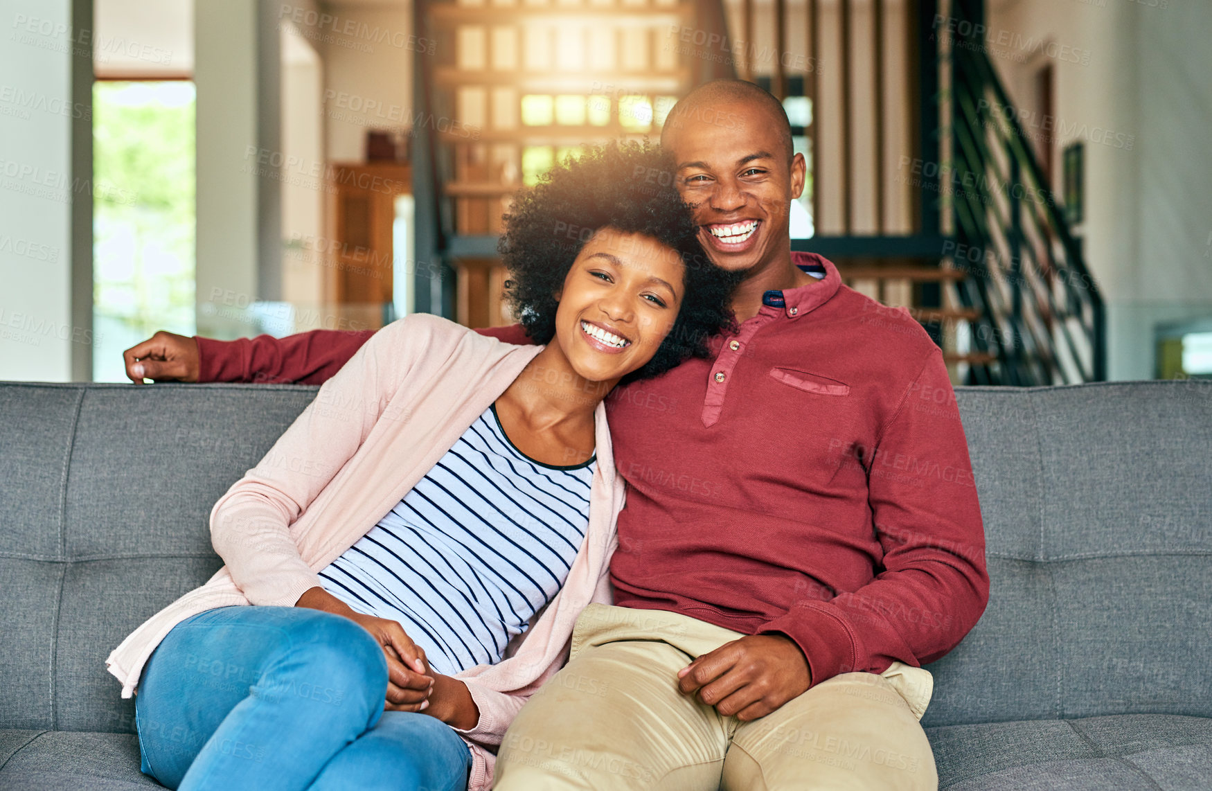 Buy stock photo Black couple, people and happy on sofa in home on portrait for bonding, love and support in Brazil. People, relationship and smile with confidence on couch in living room on break to relax and chill