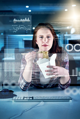 Buy stock photo Portrait of a focused young female programmer working on a computer while eating noodles in the office at work during the night