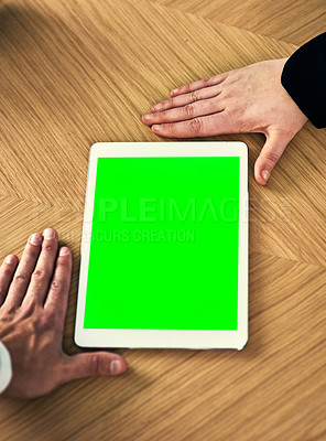 Buy stock photo Cropped shot of a businessman and businesswoman framing a digital tablet with a green screen on a desk