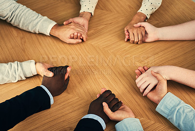 Buy stock photo Cropped shot of a group of businesspeople holding their hands in solidarity