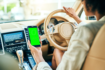 Buy stock photo Shot of an unrecognizable businesswoman holding her cellphone while driving in a car on her way to work during the day