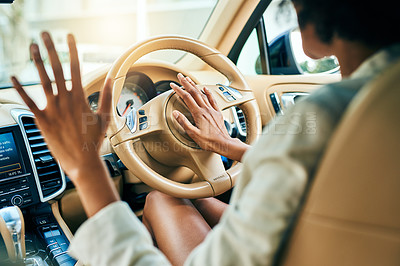 Buy stock photo Shot of an unrecognizable businesswoman driving in a car and hooting on the steering wheel while going to work during the day