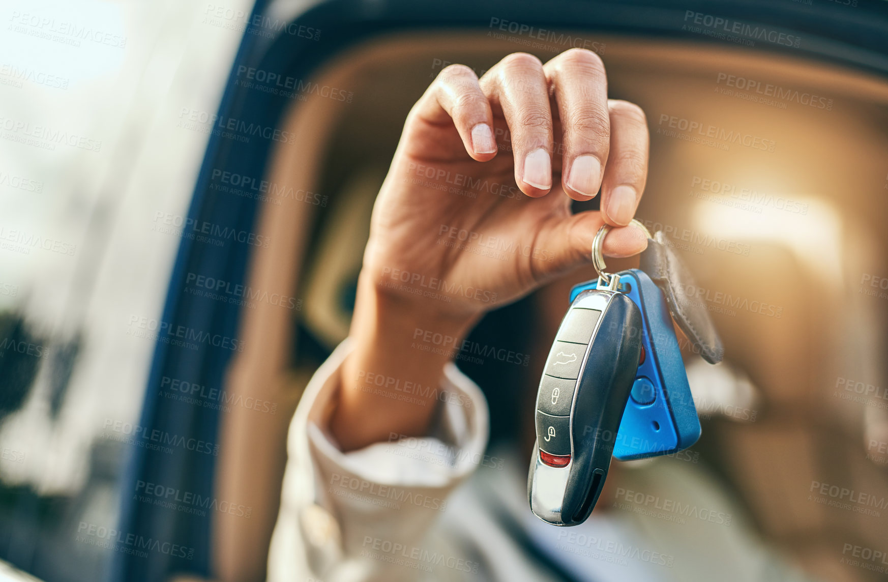 Buy stock photo Closeup of an unrecognizable businessperson holding a set of keys while being seated inside of a car during the day