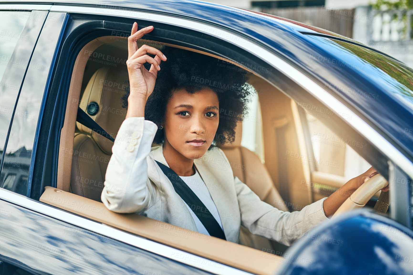 Buy stock photo Portrait of a confident young businesswoman on her way to work while driving in a car during the day