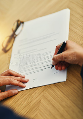 Buy stock photo Closeup shot of an unrecognizable businesswoman completing paperwork at a desk