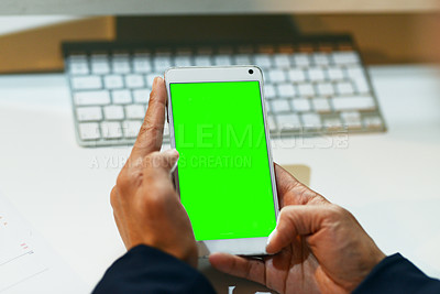 Buy stock photo Closeup shot of an unrecognizable businesswoman using a cellphone with a green screen in an office