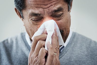 Buy stock photo Shot of a mature man blowing his nose