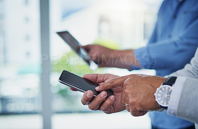 Buy stock photo Closeup shot of two unrecognizable businessmen using digital devices in an office