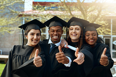 Buy stock photo Portrait of a group of young students showing thumbs up on graduation day