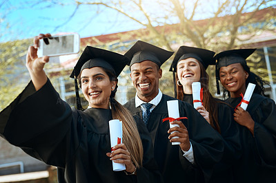 Buy stock photo Portrait of a group of students taking selfies with a mobile phone on graduation day