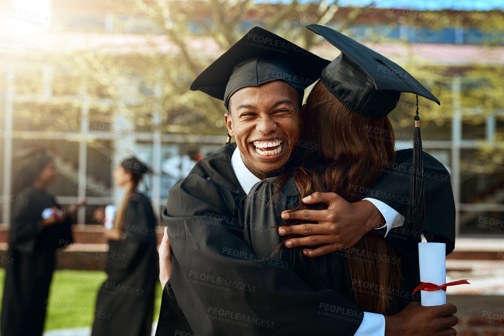 Buy stock photo Portrait of a happy young man and woman hugging on graduation day