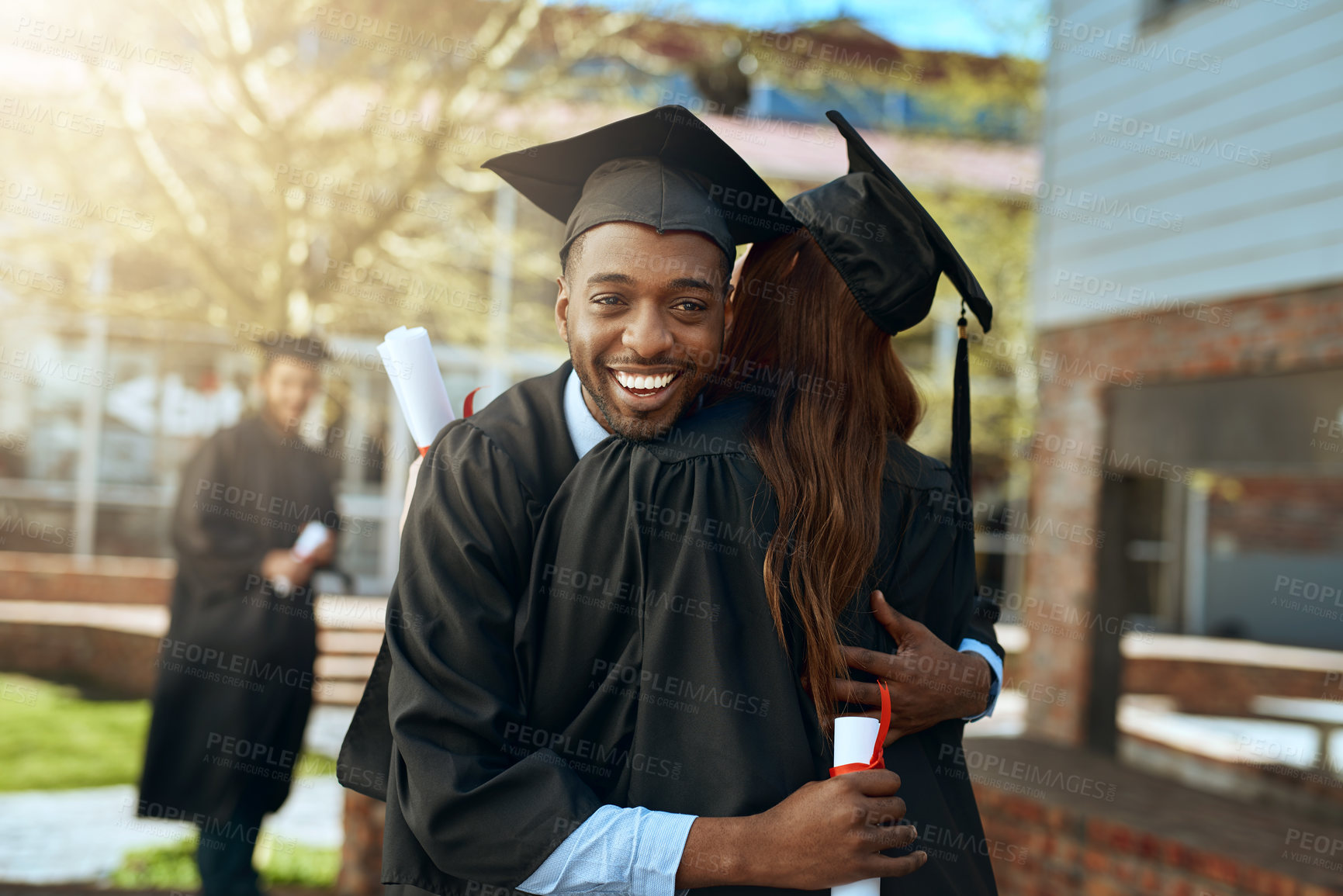 Buy stock photo Happy, man and hug for graduation celebration, education achievement and diploma success. Excited, students and embrace woman for certificate, graduate together and learning goals for campus ceremony