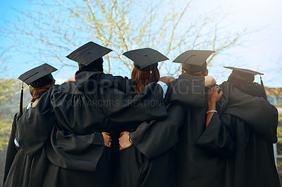 Buy stock photo Embrace, group of graduates and together with joy on graduation day or celebrating academic achievement and outdoors. Certification, young students and hug outside or robes or hats and education