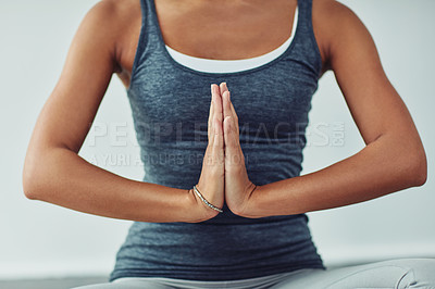 Buy stock photo Shot of an unrecognizable woman practicing yoga at home