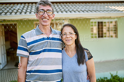 Buy stock photo Portrait of an affectionate mature couple standing together in their backyard