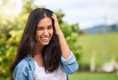 Buy stock photo Cropped shot of an attractive young woman standing outdoors