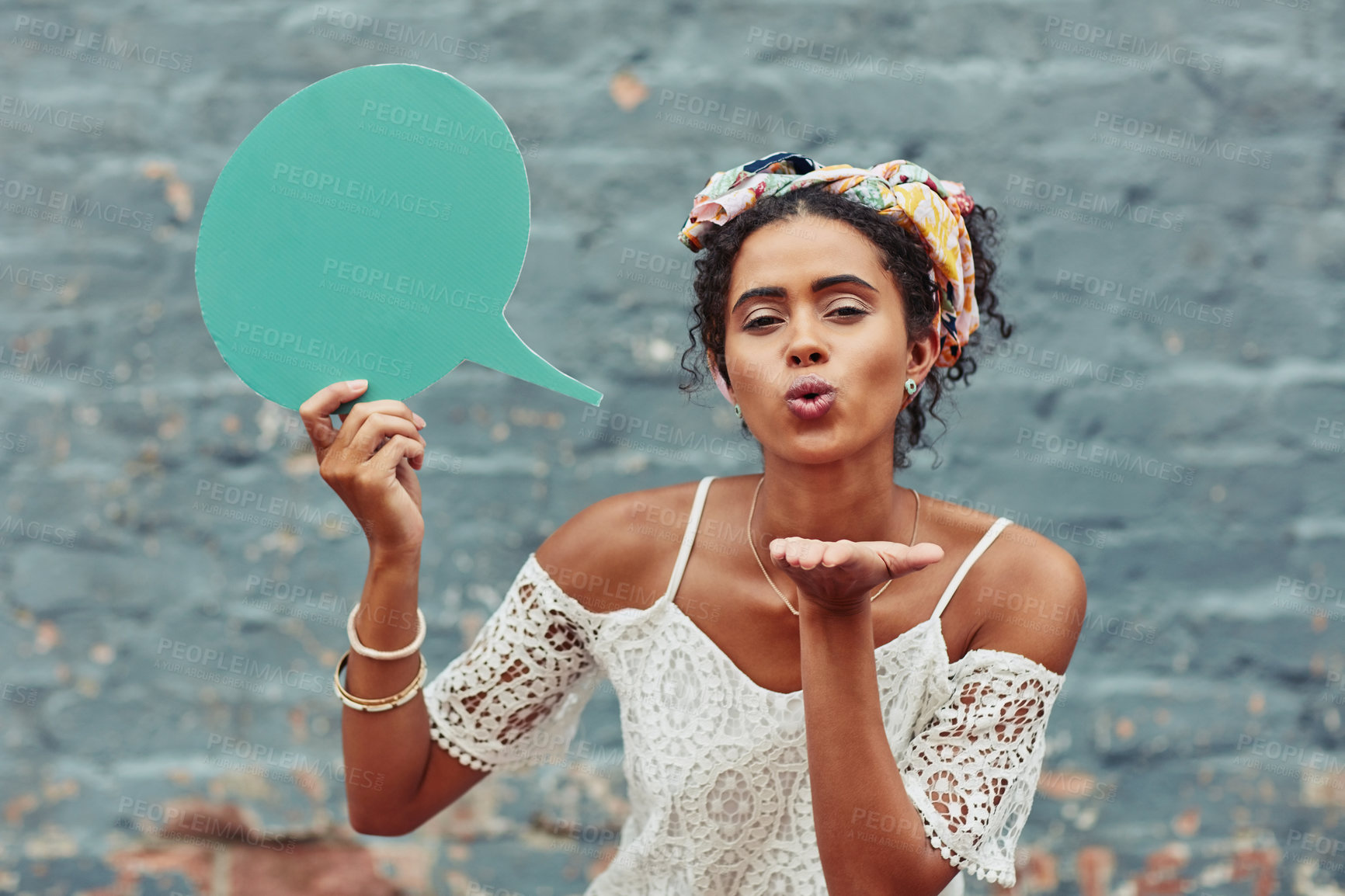 Buy stock photo Girl, portrait and blowing kiss with speech bubble for comment, feedback or social media on a wall background. Young female person fashion with shape or quote for question or news on mockup space