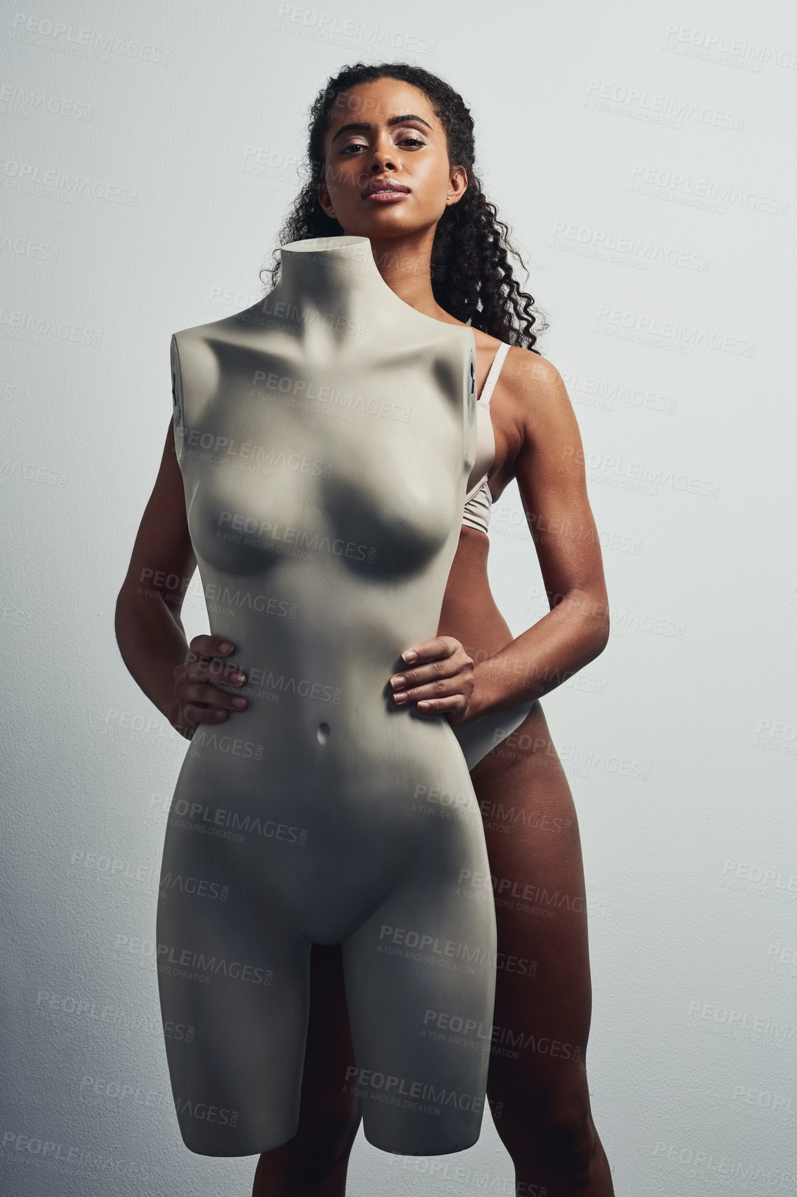 Buy stock photo Studio shot of an attractive young woman posing with a mannequin against a grey background