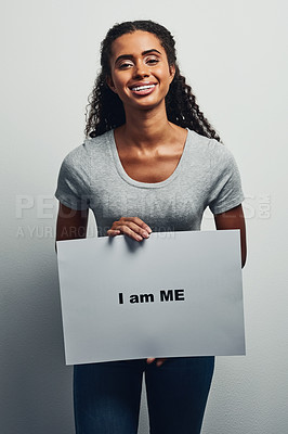 Buy stock photo Studio shot of an attractive young woman holding a placard that reads 