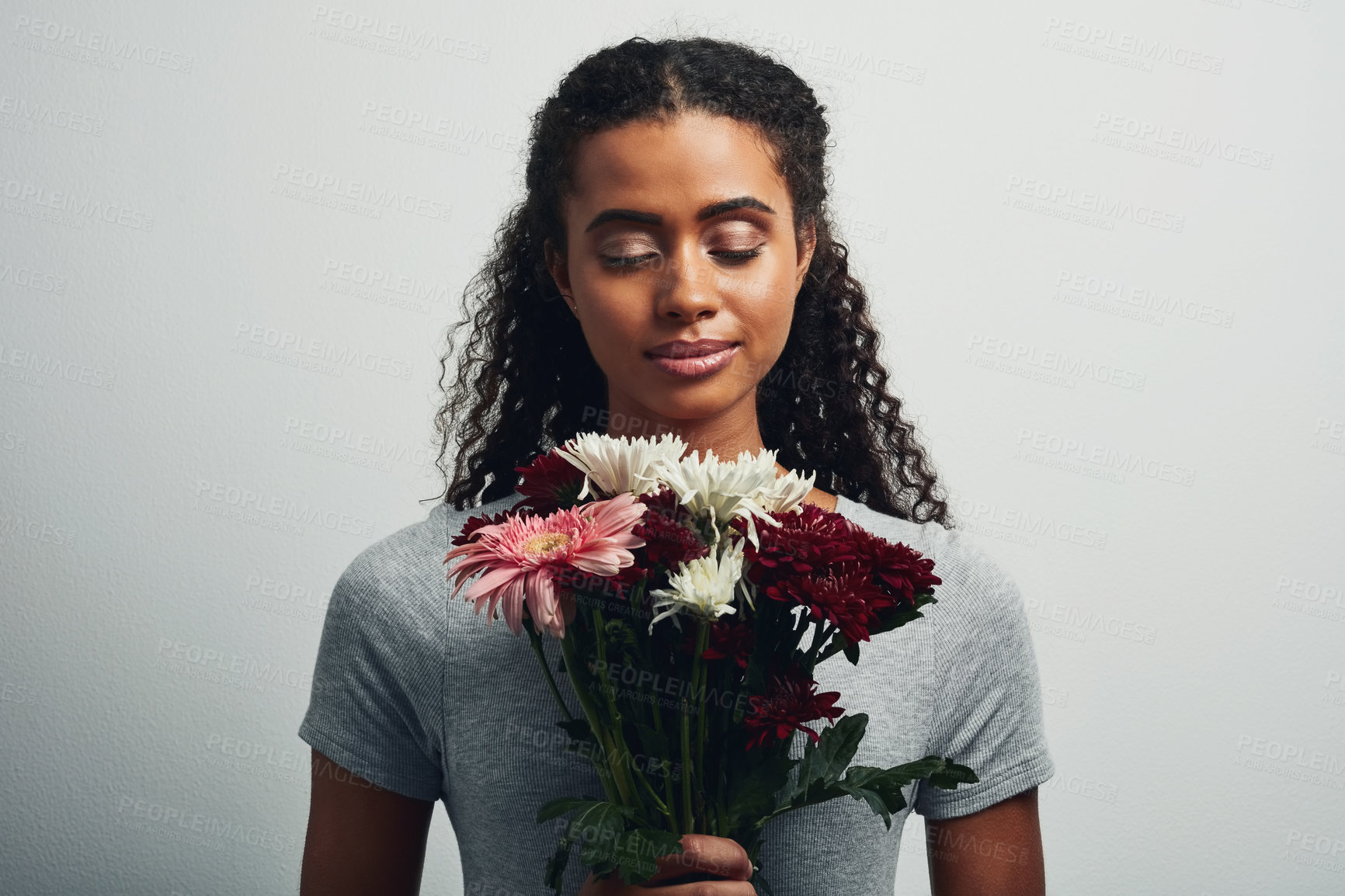 Buy stock photo Smile, flowers and aroma with woman in studio for gift, satisfaction and spring fashion. Face, happy and trendy floral present with model and bouquet isolated on gray background for natural smell