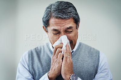 Buy stock photo Shot of a mature man blowing his nose