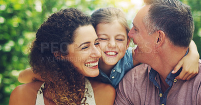 Buy stock photo Shot of an affectionate little girl spending quality time with her mother and father outdoors