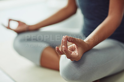 Buy stock photo Shot of an unrecognizable woman practicing yoga at home
