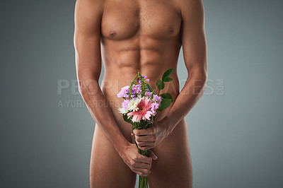 Buy stock photo Studio shot of an unrecognizable shirtless man holding a bunch of flowers against a grey background