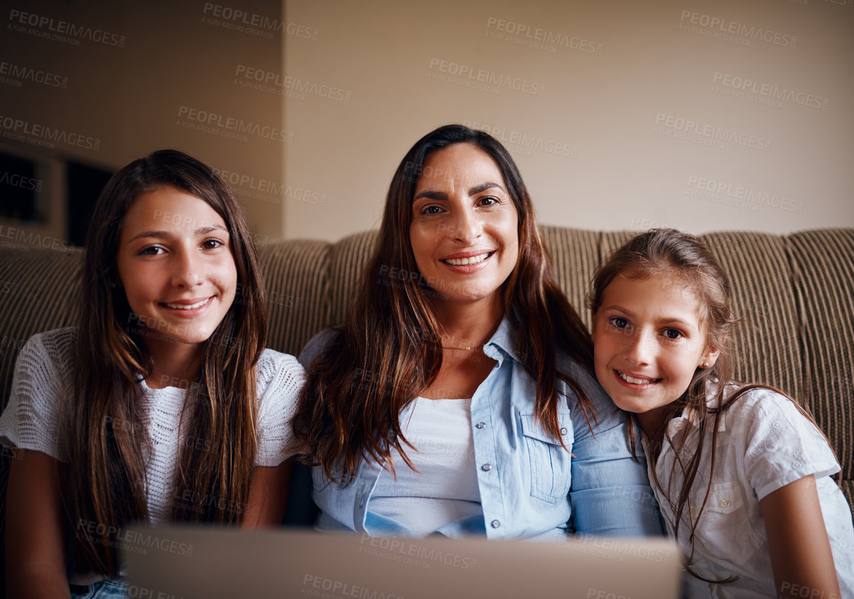 Buy stock photo Cropped portrait of an attractive mother watching movies on a laptop with her two daughters at home