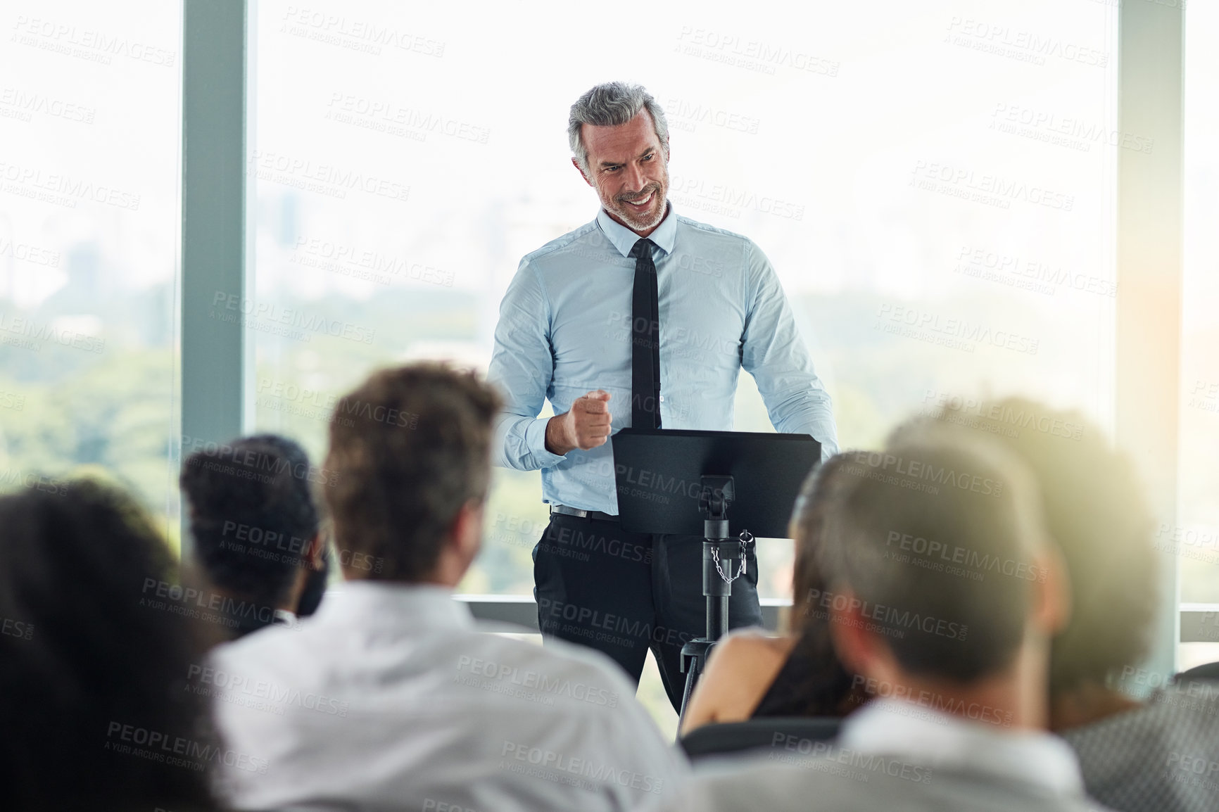 Buy stock photo Cropped shot of a handsome mature businessman speaking at a business conference
