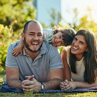 Buy stock photo Portrait, dad and mom with girl in park, connection and bonding together with smile as happy family. Garden, father and mother with child for picnic, relax or hug embrace on vacation outdoor in Spain