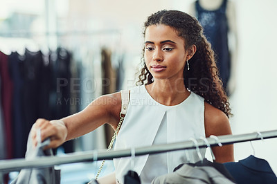 Buy stock photo Shot of an attractive young woman on a shopping spree in a boutique