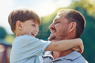 Buy stock photo Shot of a father bonding with his little son outdoors