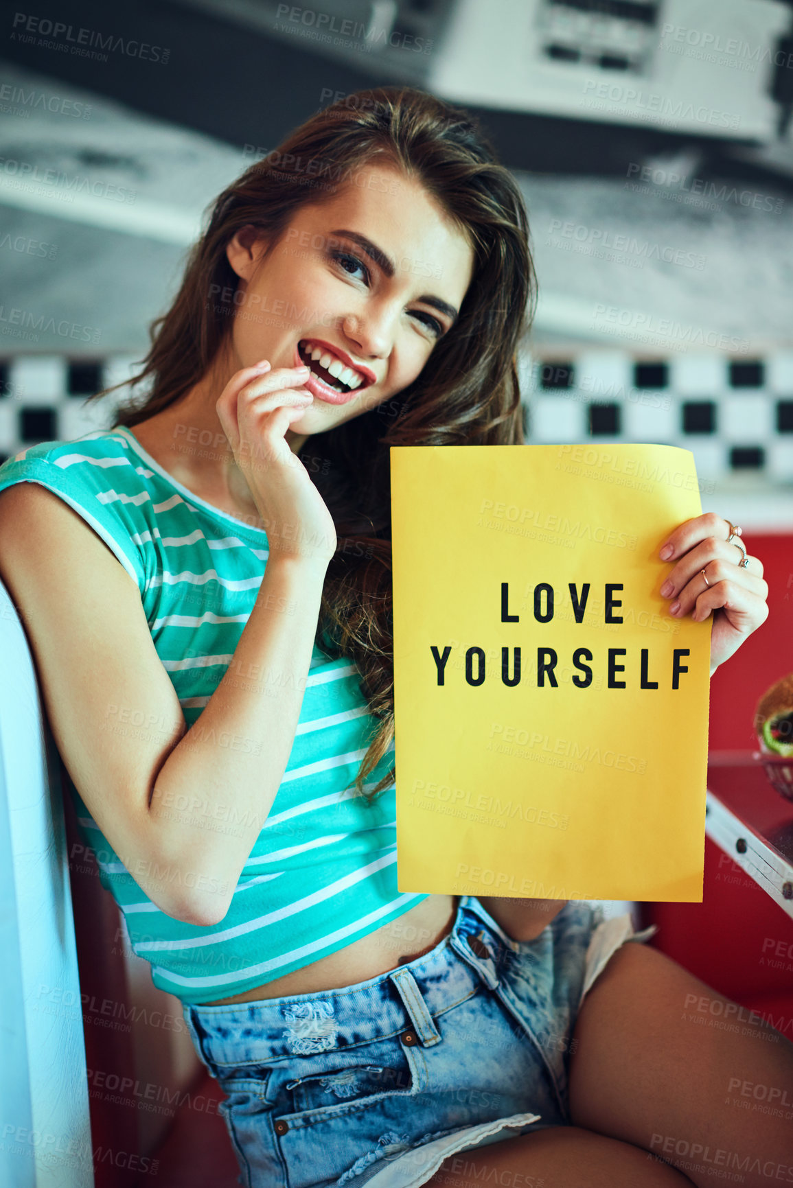 Buy stock photo Portrait, happy and woman with sign to love yourself, care and empowerment at retro diner. Paper, smile and girl with poster for affection, laugh and respect with message for motivation on womens day