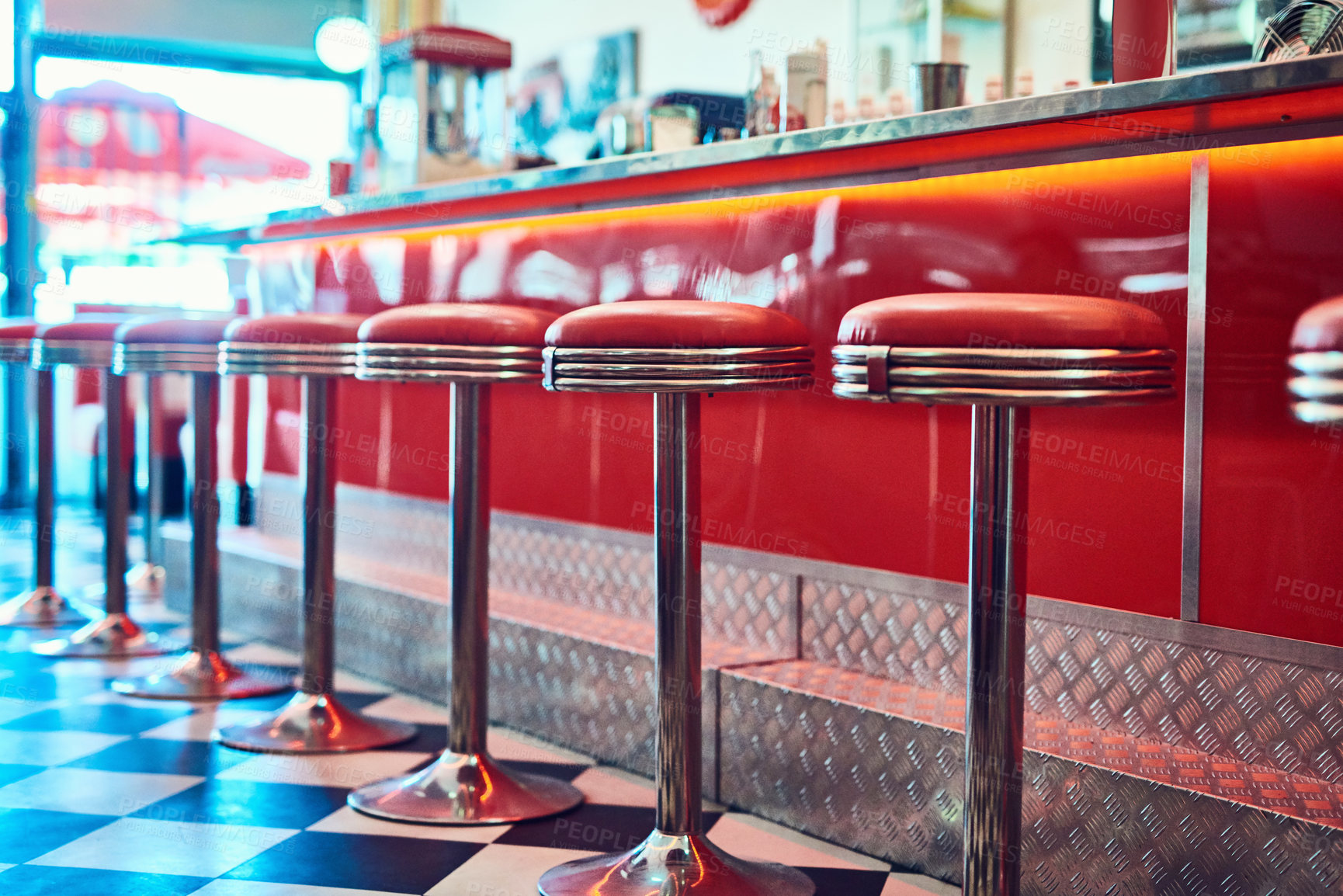 Buy stock photo Trendy, vintage and retro interior in a diner, restaurant or cafeteria with funky decor. Booth, old school and chairs by a counter or bar in a groovy, vibrant and stylish old fashioned empty cafe.