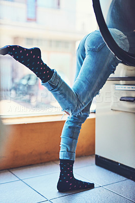 Buy stock photo Shot of an unrecognizable woman's bottom half showing her wearing black socks while doing her washing in a laundry room