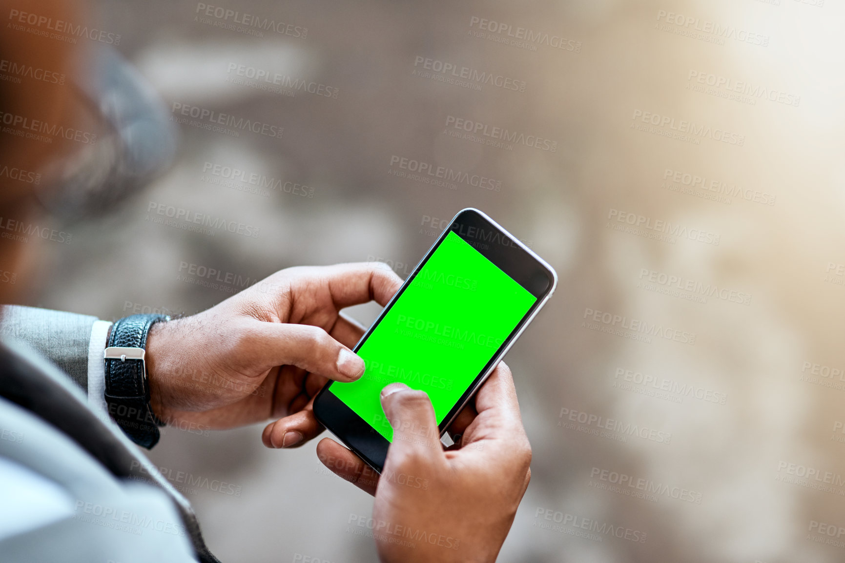Buy stock photo Closeup shot of an unrecognizable businessman using a cellphone with a screen green in an office