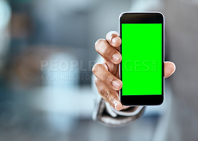 Buy stock photo Closeup shot of an unrecognizable businessman holding up a cellphone with a green screen in an office