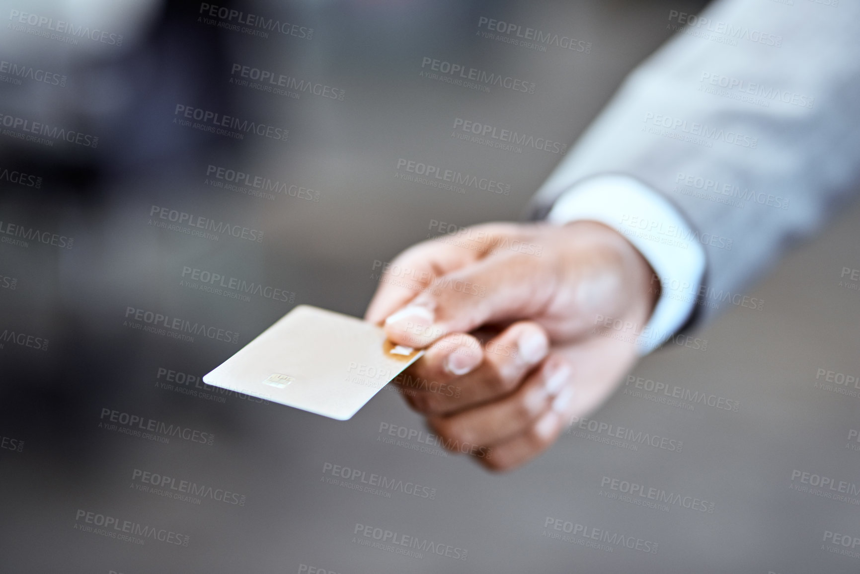 Buy stock photo Closeup shot of an unrecognizable businessman holding a credit card in an office
