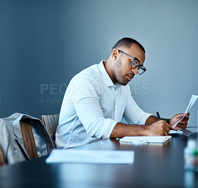 Buy stock photo Businessman, accountant and writing with documents for finance, report or company budget at office. Young man or employee taking notes with paperwork for financial expenses or bills at workplace