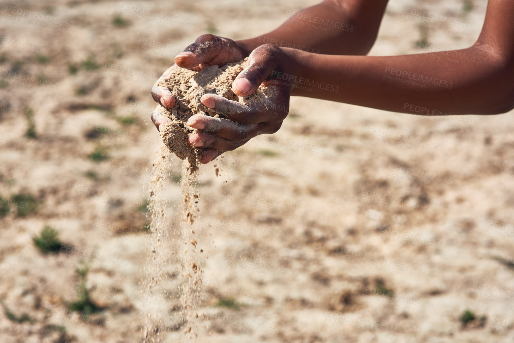 Buy stock photo Shot of an unrecognizable person holding two hands full of sand showing how dry the area is outside